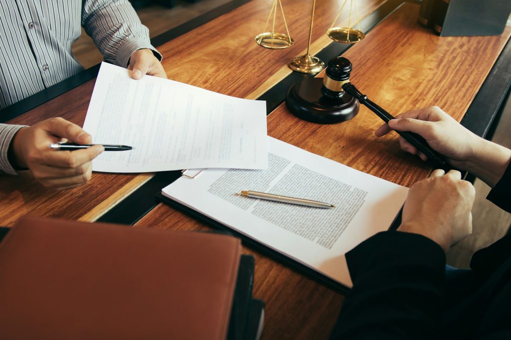 Client is bringing the documents to clarify the law to the lawyer at the prosecutor office.