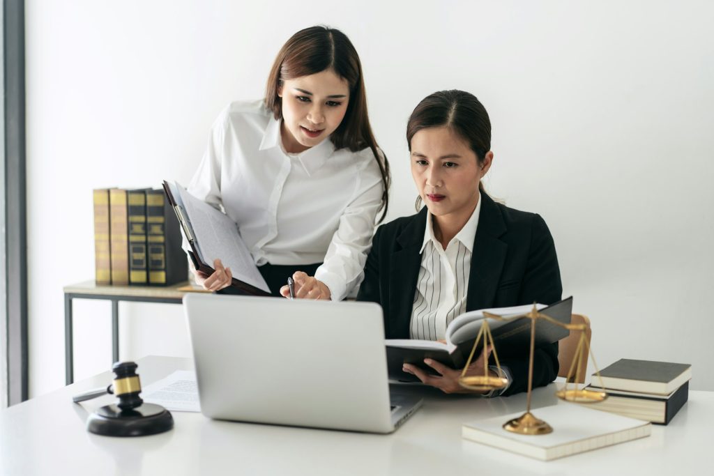 Female lawyer is holding law book and giving advice about laws a