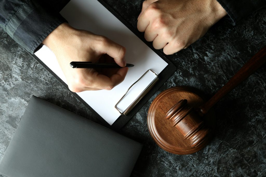 Judge make notes in clipboard, law concept, close up