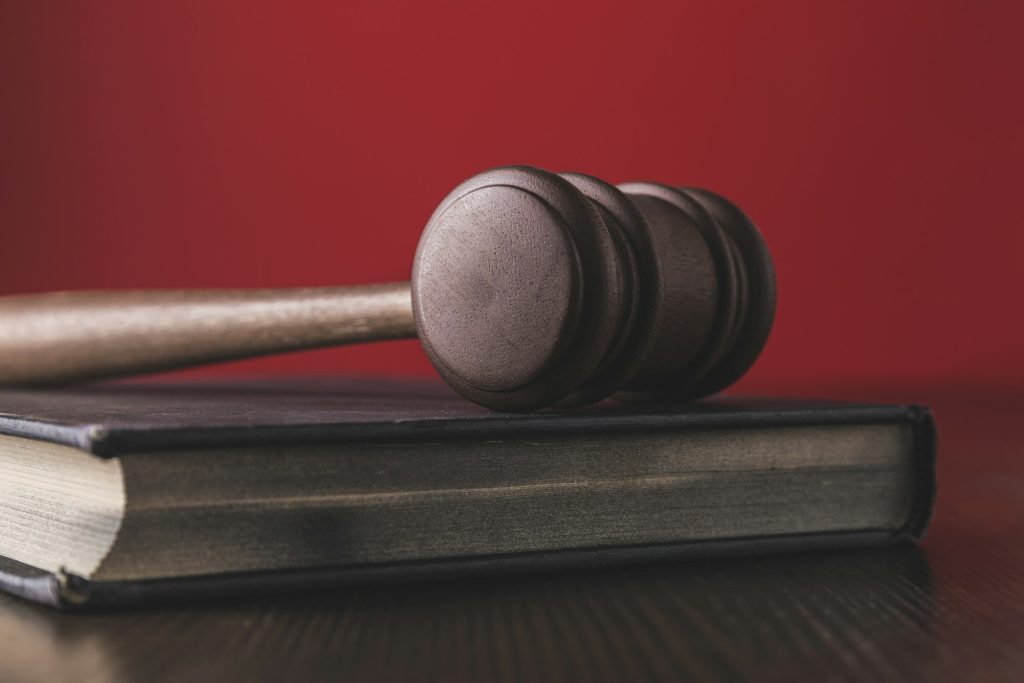 juridical book with hammer on wooden table, law concept