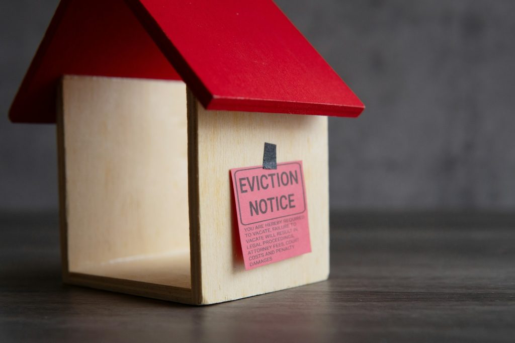 Toy house and eviction notice.